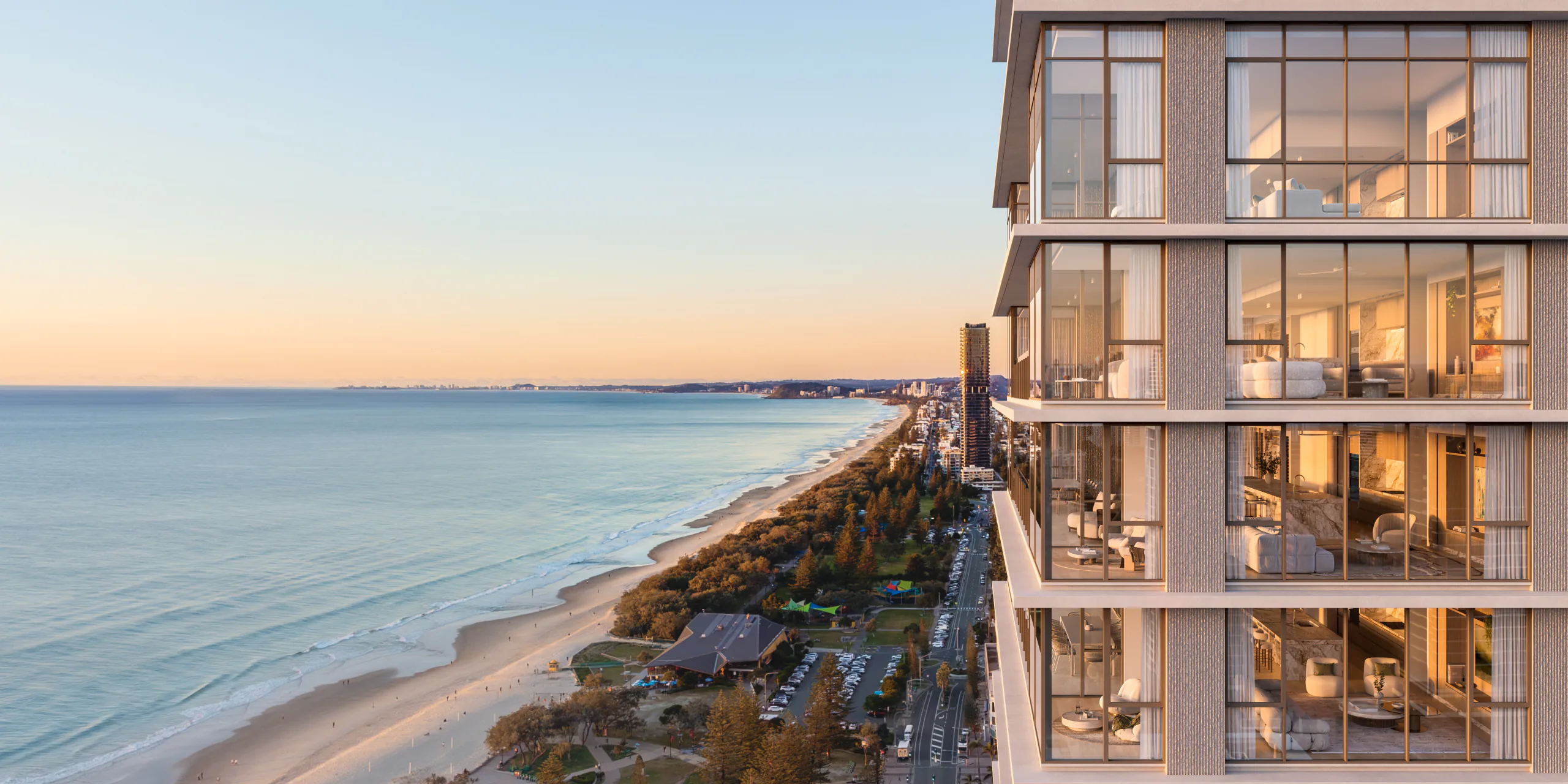 Aerial glide along the surf line past the glowing Breeze facade